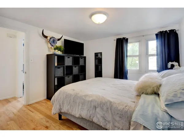 a bedroom with a bed and a television