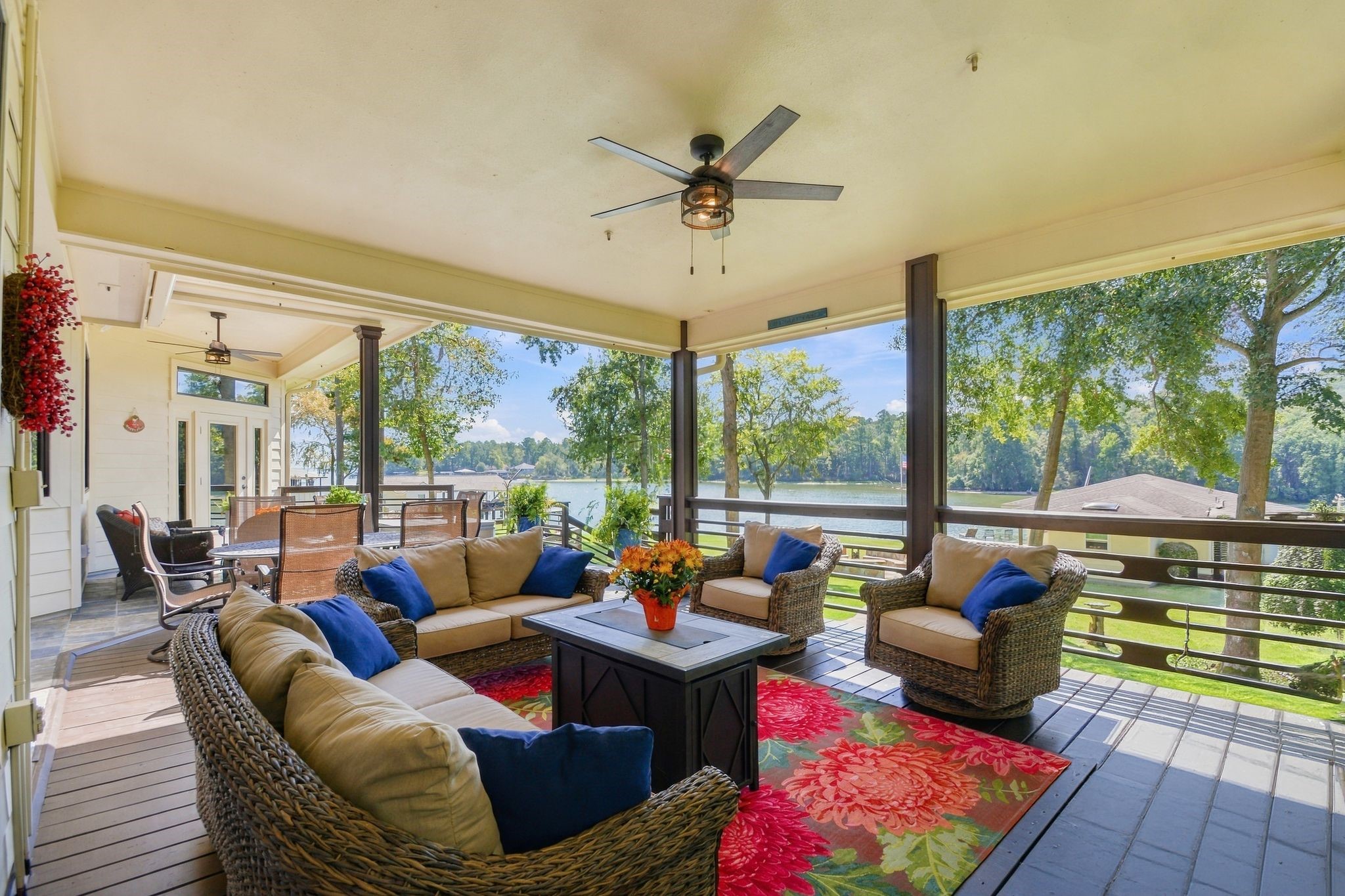 20341 Bay Hill Road Point Blank, TX 77364 - Photo 31 of 50 Inviting covered patio with comfortable seating, vibrant decor, and stunning lake views, perfect for relaxing or entertaining.