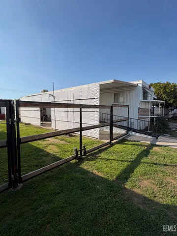 a view of a backyard with a garden and deck