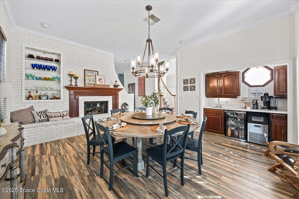 466 Lanternback Island Drive Satellite Beach, FL 32937 - Photo 18 of 117 a view of a dining room with furniture a chandelier and wooden floor