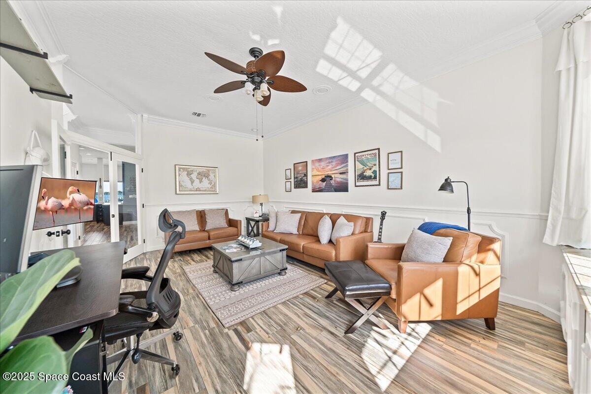 466 Lanternback Island Drive Satellite Beach, FL 32937 - Photo 25 of 117 a living room with furniture and a flat screen tv