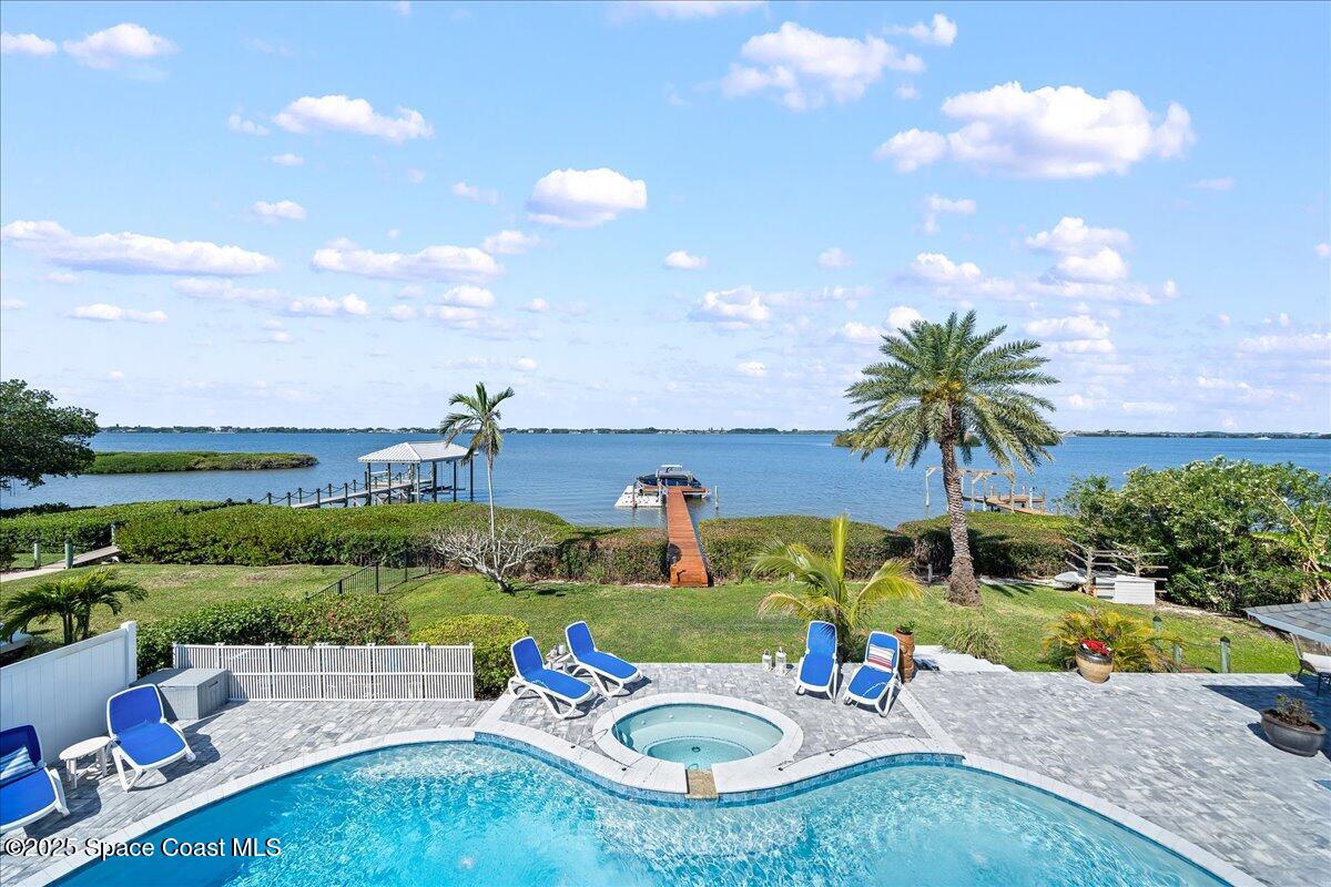 466 Lanternback Island Drive Satellite Beach, FL 32937 - Photo 43 of 117 a view of a swimming pool and a yard