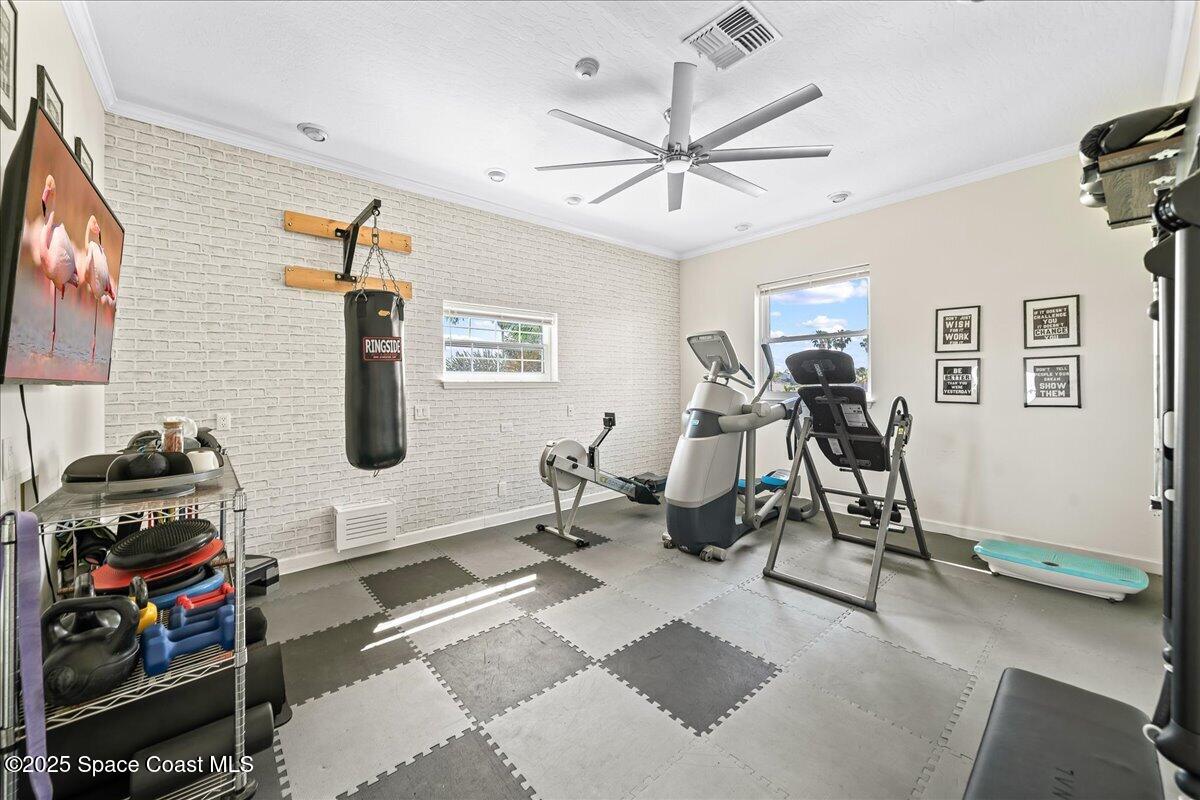 466 Lanternback Island Drive Satellite Beach, FL 32937 - Photo 44 of 117 a living room with furniture a air conditioner vent and a flat screen tv