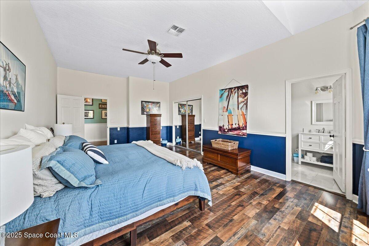 466 Lanternback Island Drive Satellite Beach, FL 32937 - Photo 47 of 117 a bedroom with a bed and wooden floor