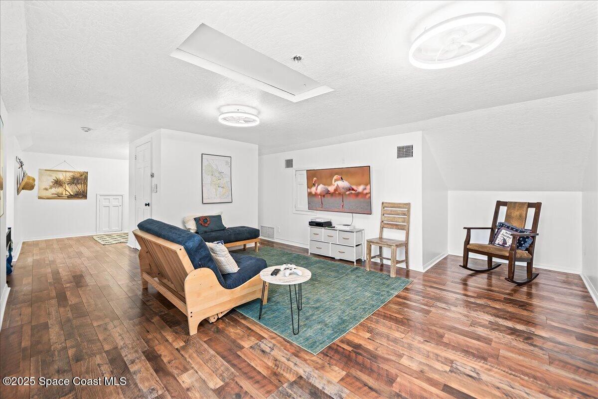 466 Lanternback Island Drive Satellite Beach, FL 32937 - Photo 58 of 117 a living room with furniture and a wooden floor