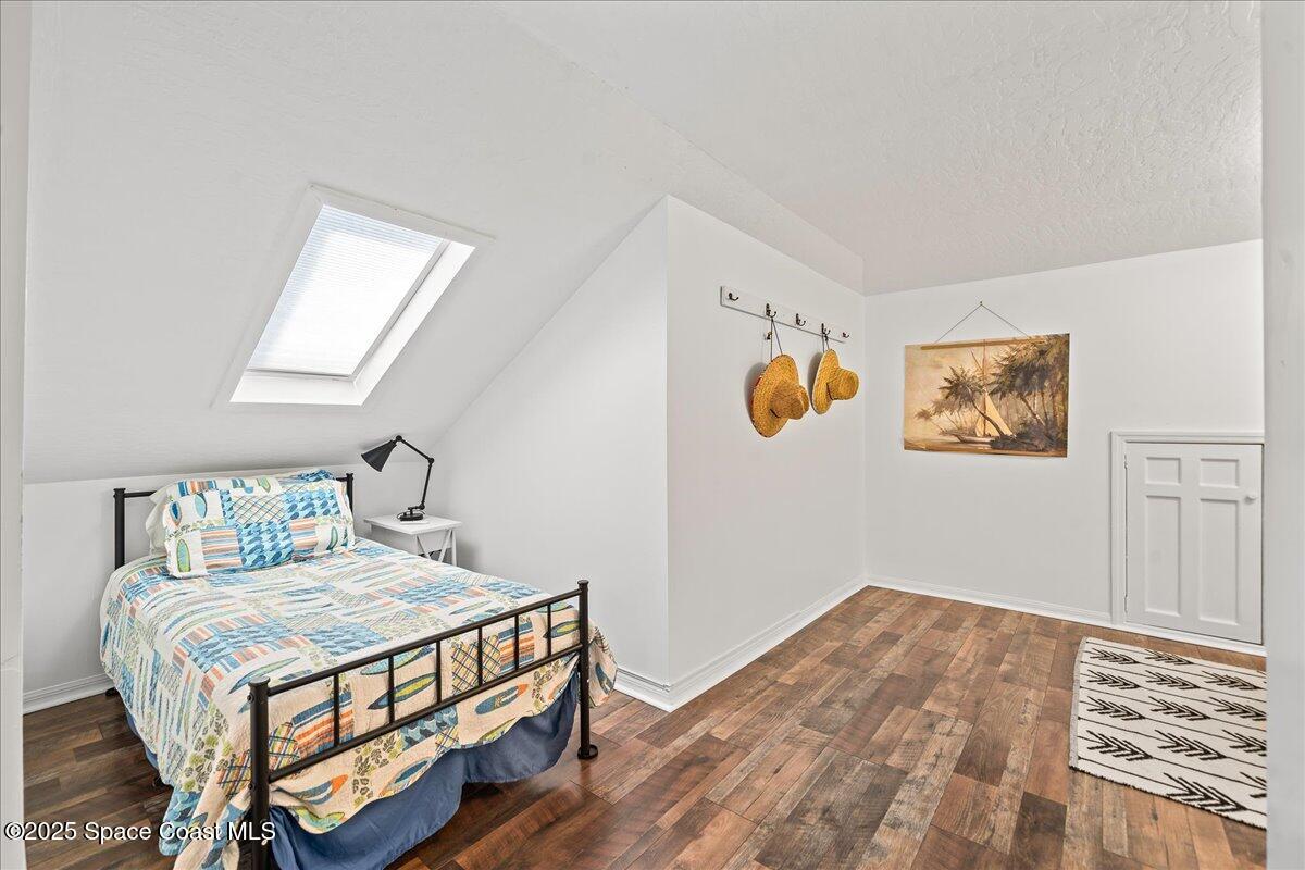 466 Lanternback Island Drive Satellite Beach, FL 32937 - Photo 60 of 117 a bedroom with a bed and wooden floor