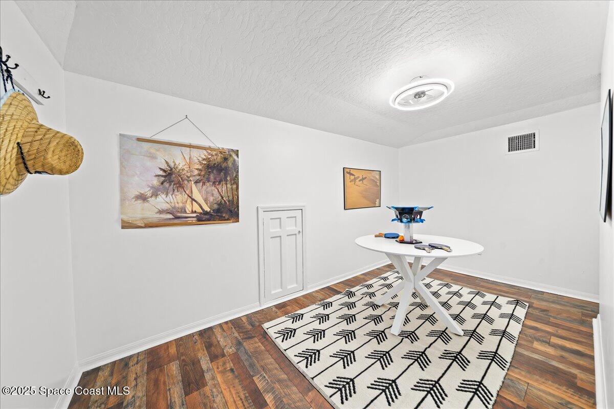 466 Lanternback Island Drive Satellite Beach, FL 32937 - Photo 61 of 117 a bedroom with a bed and a lamp on the dresser