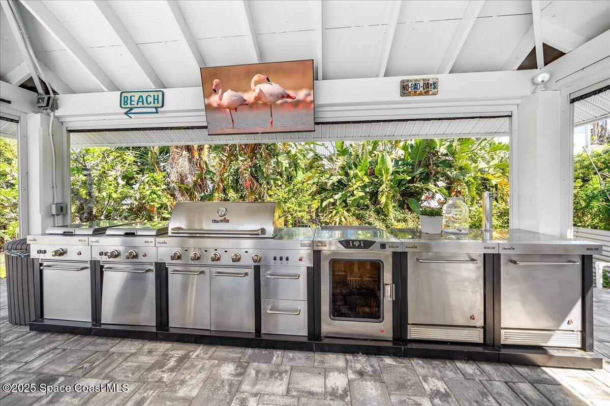466 Lanternback Island Drive Satellite Beach, FL 32937 - Photo 63 of 117 a kitchen with stainless steel appliances granite countertop a stove and cabinets
