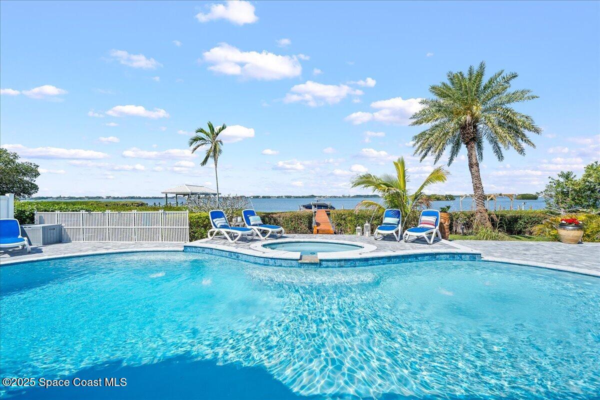 466 Lanternback Island Drive Satellite Beach, FL 32937 - Photo 71 of 117 a view of a swimming pool and a yard