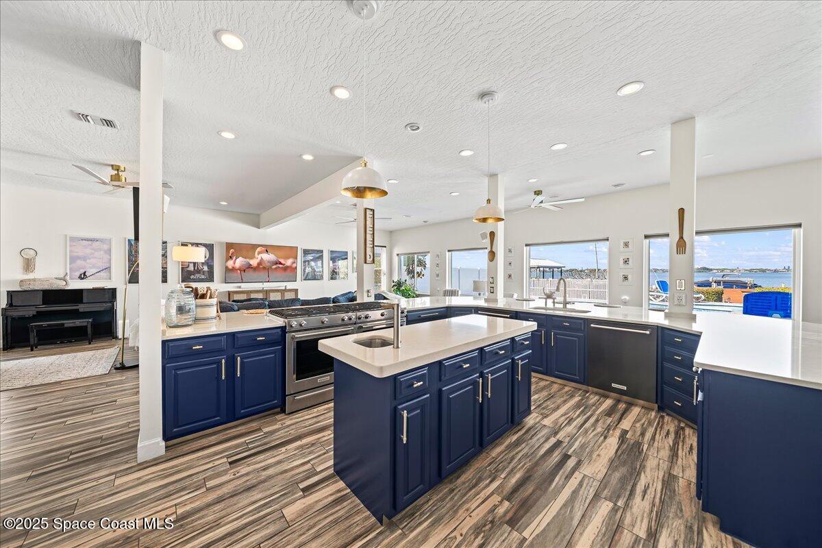 466 Lanternback Island Drive Satellite Beach, FL 32937 - Photo 8 of 117 a large kitchen with stainless steel appliances granite countertop plenty wooden cabinets counter space a sink and a wooden floor