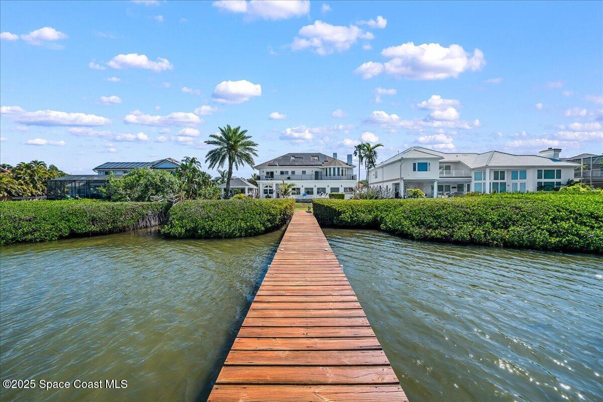 466 Lanternback Island Drive Satellite Beach, FL 32937 - Photo 83 of 117 a front view of a house with a yard and potted plants