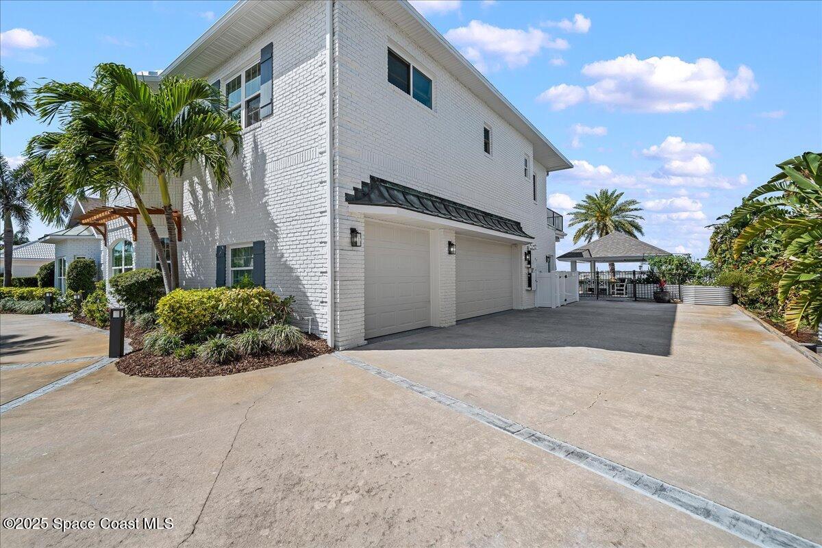 466 Lanternback Island Drive Satellite Beach, FL 32937 - Photo 93 of 117 a backyard of a house with potted plants and palm tree