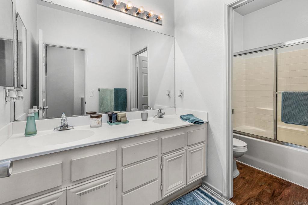 625 Sumner Way, Unit 2 Oceanside, CA 92058 - Photo 14 of 31 a bathroom with a double vanity sink and mirror