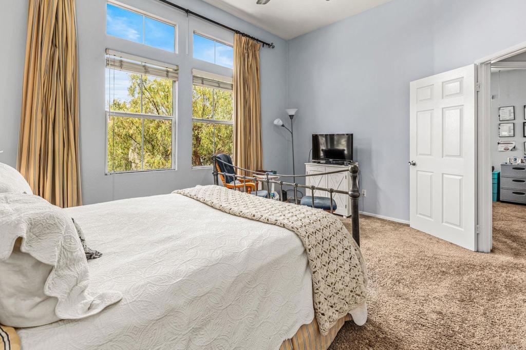 625 Sumner Way, Unit 2 Oceanside, CA 92058 - Photo 20 of 31 a bedroom with a bed and a flat tv screen next to a window