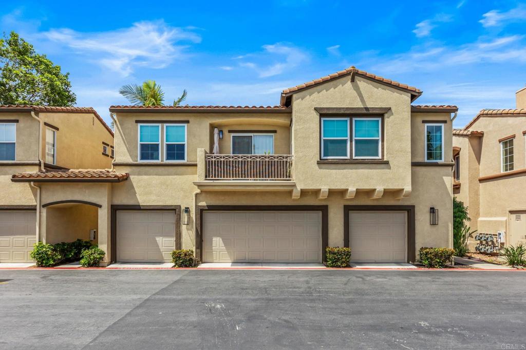 625 Sumner Way, Unit 2 Oceanside, CA 92058 - Photo 28 of 31 a front view of a house with a yard and garage