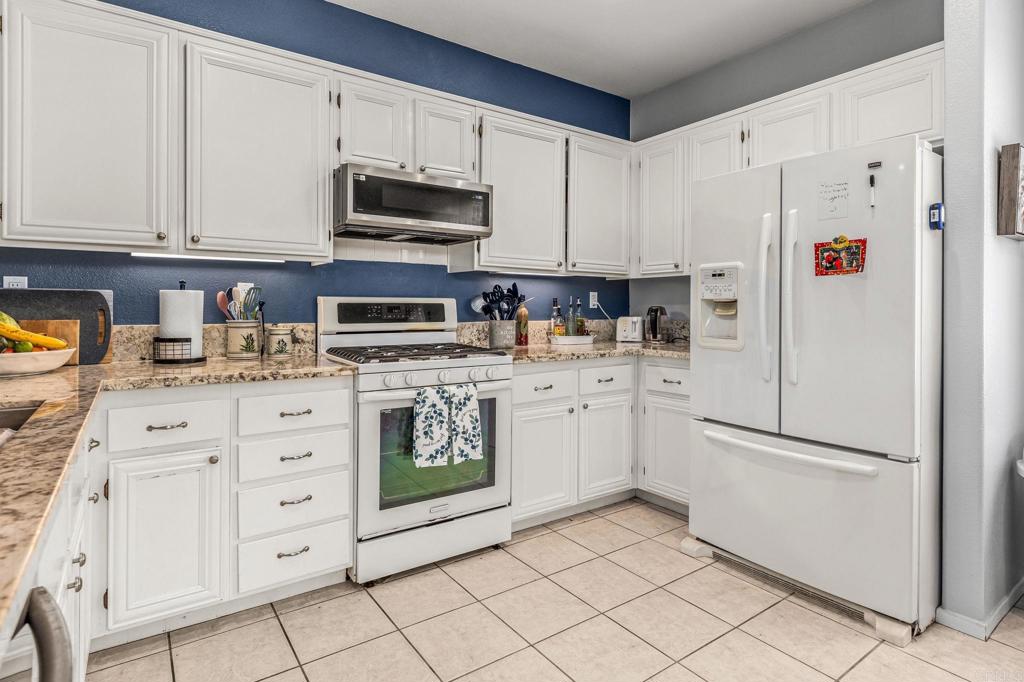 625 Sumner Way, Unit 2 Oceanside, CA 92058 - Photo 8 of 31 a kitchen with white cabinets and white appliances