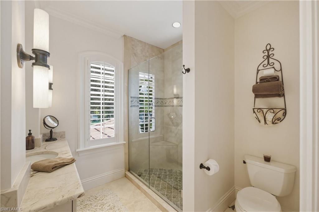 361 Pirates Bight Naples, FL 34103 - Photo 34 of 45 a bathroom with a granite countertop sink a mirror and a shower