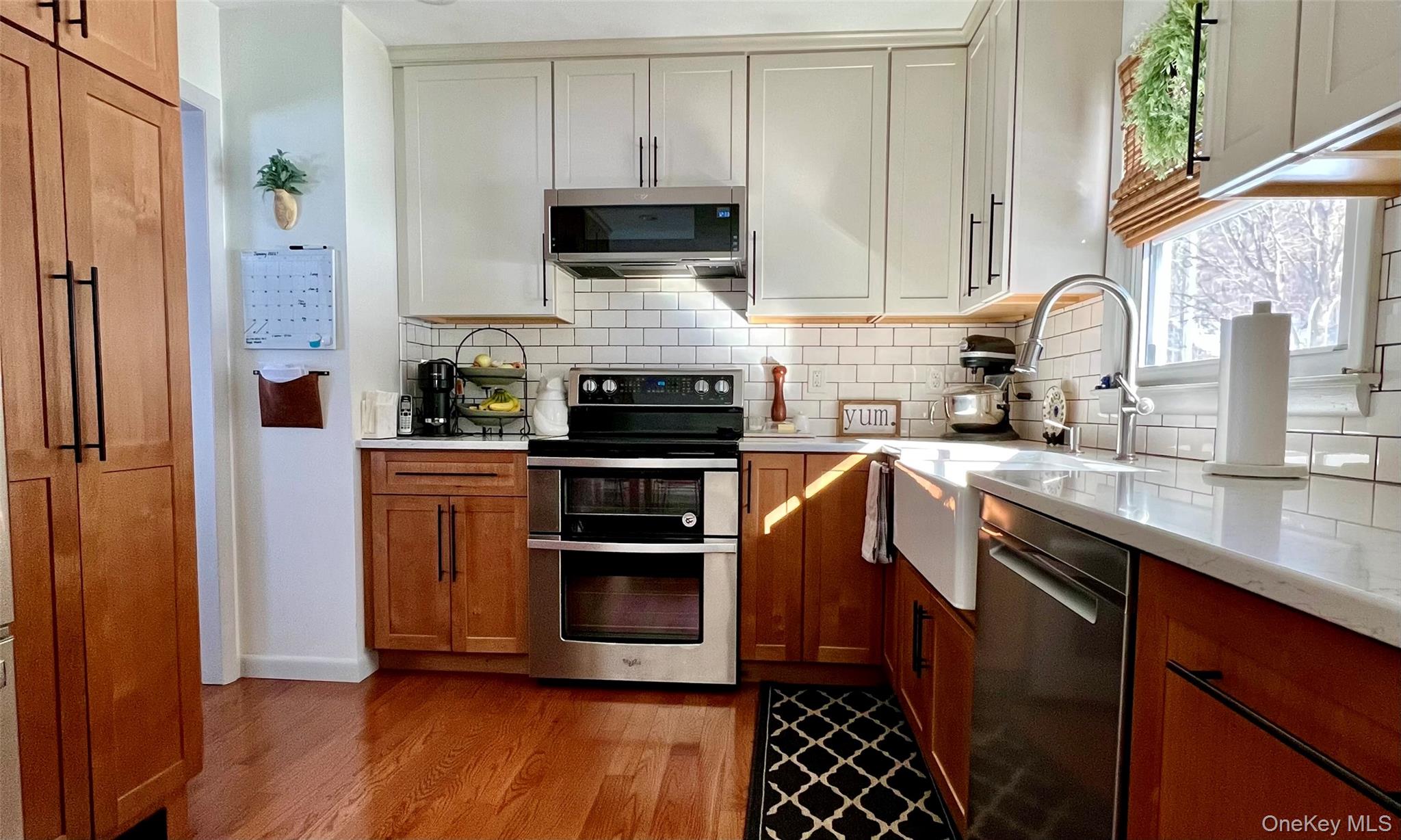 2 Garden Place Beacon, NY 12508 - Photo 15 of 33 a kitchen with stainless steel appliances a stove a sink a microwave and cabinets