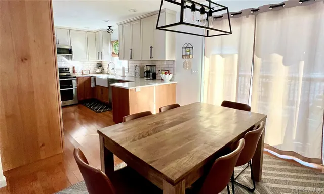 a kitchen with kitchen island a stove a table and a refrigerator