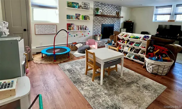 a living room with furniture a rug and a fireplace