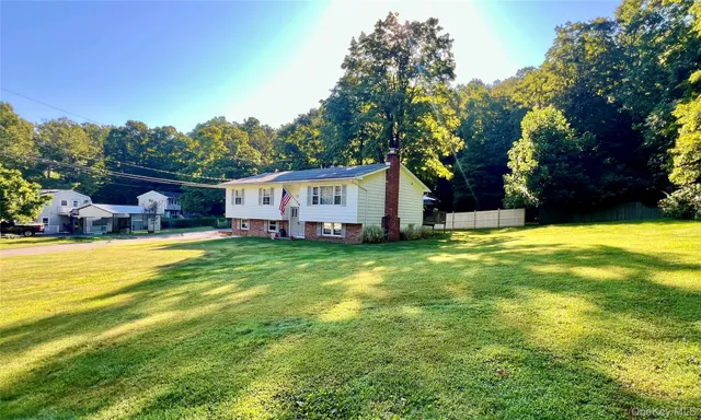 a view of a house with a yard patio and swimming pool