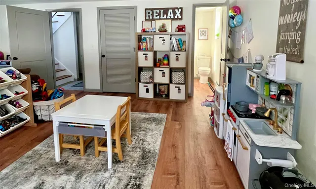 a dining room with furniture and wooden floor