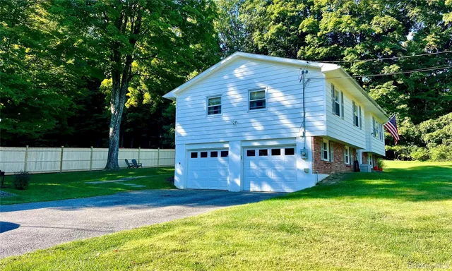 a view of a house with a yard porch and sitting area