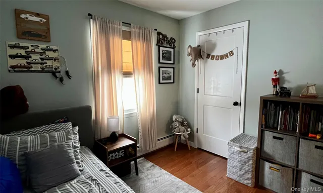 a bedroom with furniture and a window