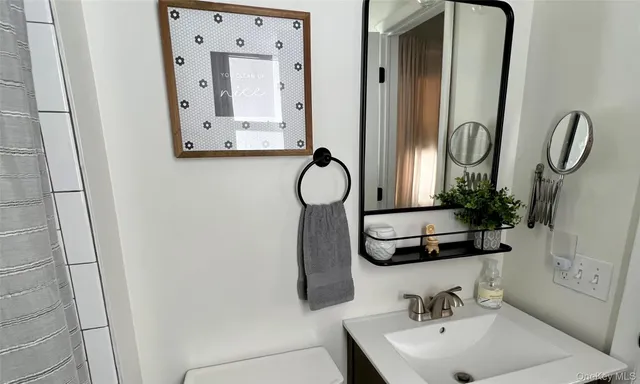 a bathroom with mirror and sink