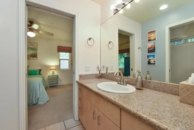 a en suite bathroom with a sink and a mirror