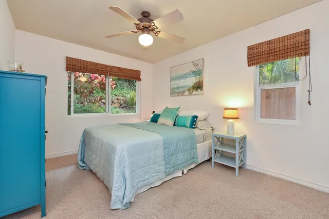 a spacious bedroom with a bed and a window