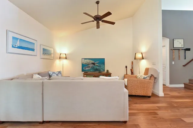 a living room with furniture and a wooden floor