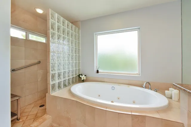 a bathroom with a bathtub and shower