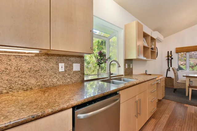 a kitchen with sink and cabinets