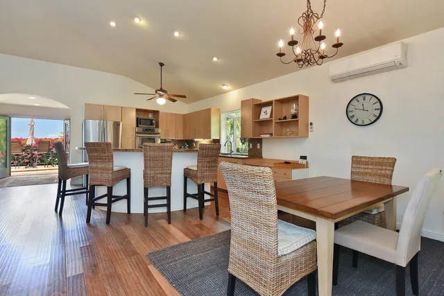 a view of a dining room with furniture and wooden floor