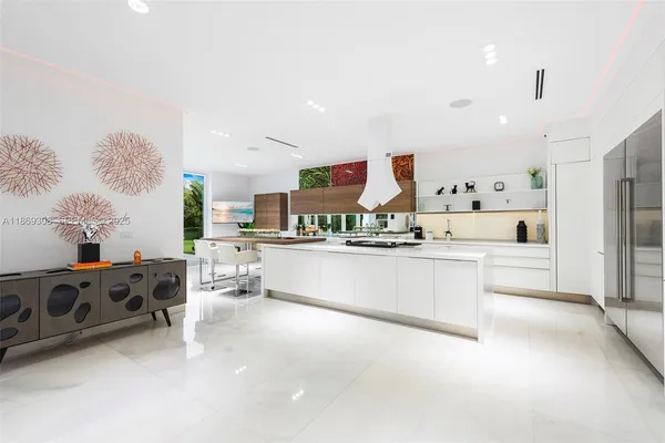 a large white kitchen with stainless steel appliances