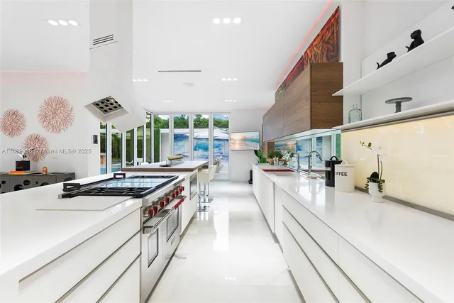 a kitchen with stainless steel appliances granite countertop a sink and a stove