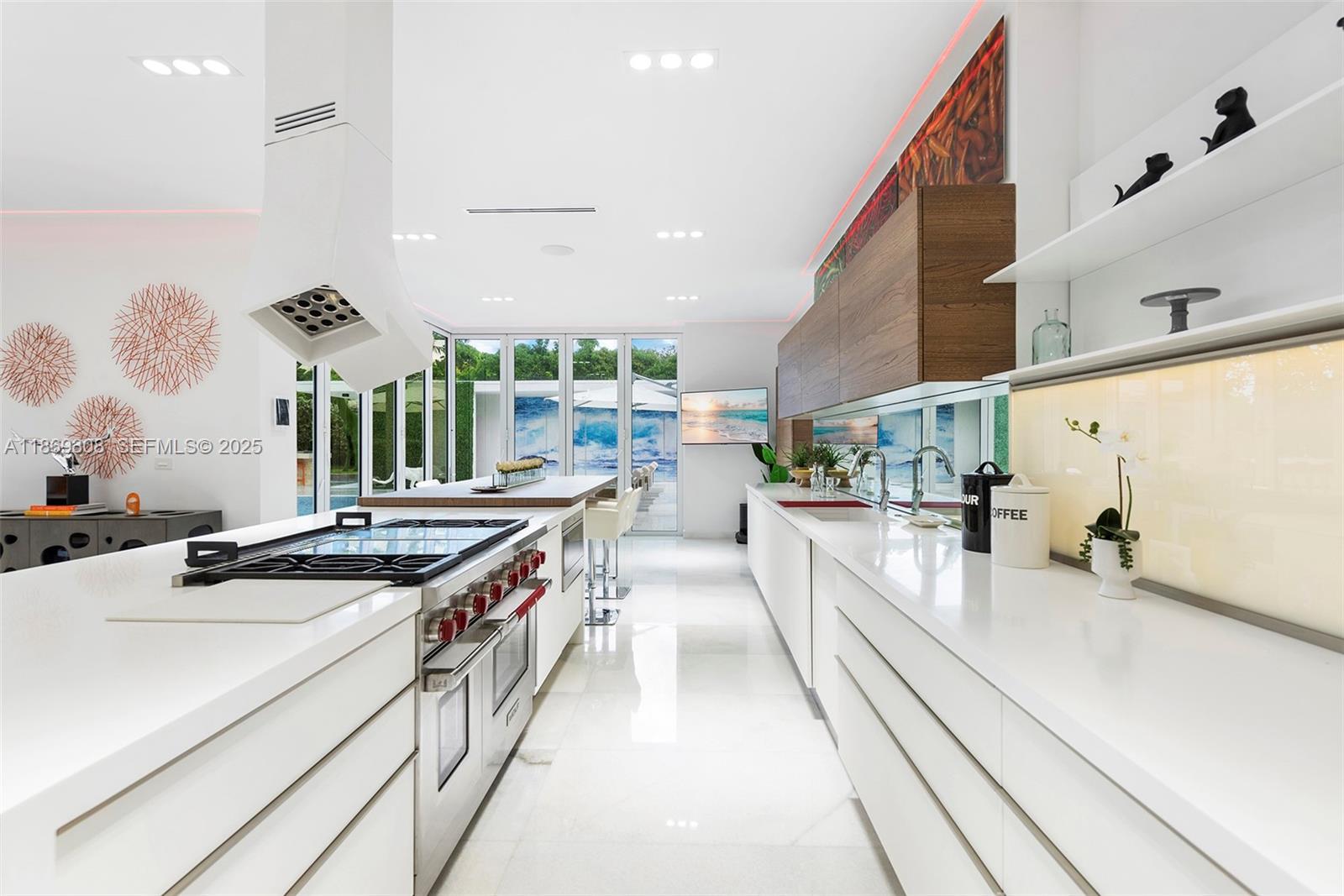 7450 Southwest 102nd Street Pinecrest, FL 33156 - Photo 14 of 51 a kitchen with stainless steel appliances granite countertop a sink and a stove