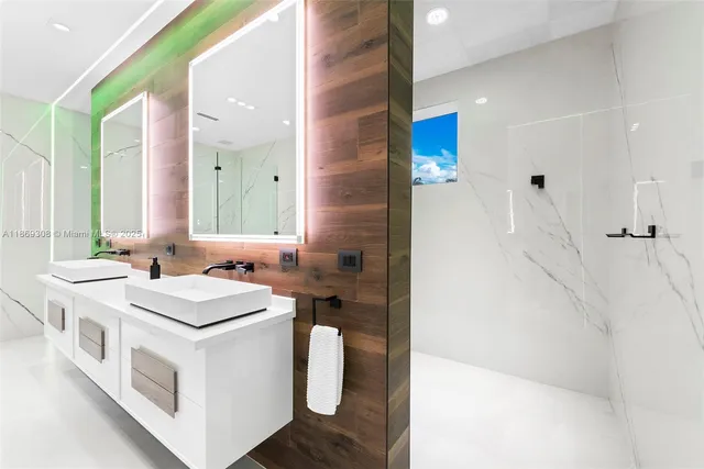 an empty room with wooden floor and a bathroom view