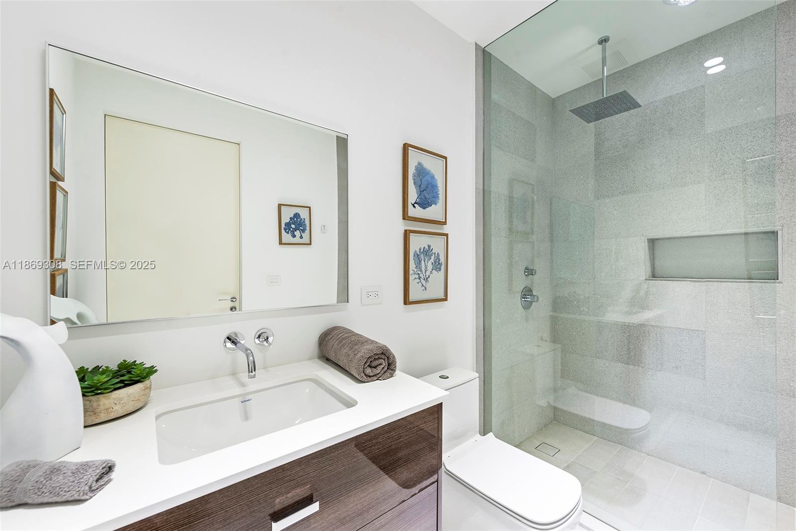 7450 Southwest 102nd Street Pinecrest, FL 33156 - Photo 32 of 51 a bathroom with a sink toilet a mirror and shower