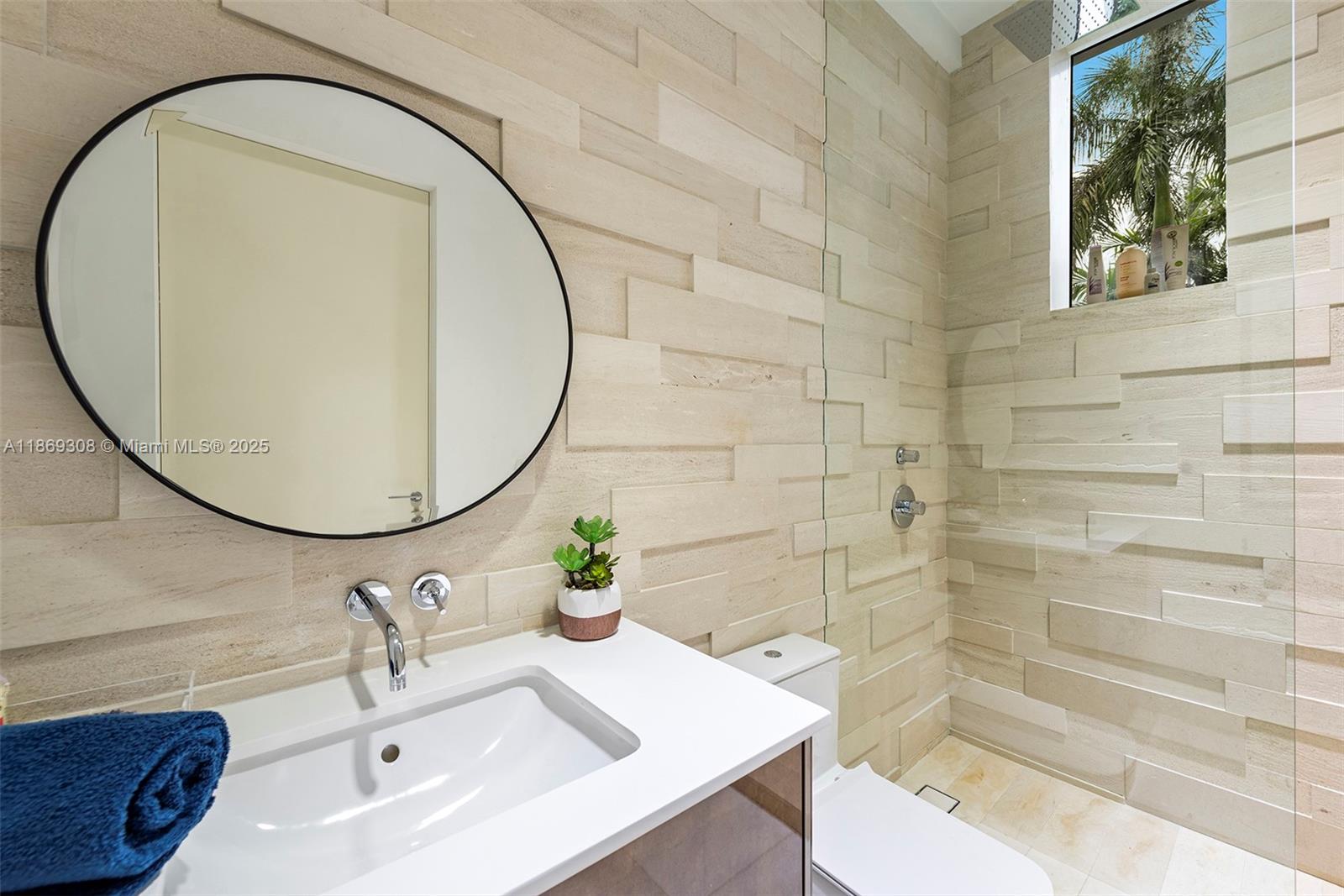 7450 Southwest 102nd Street Pinecrest, FL 33156 - Photo 34 of 51 a bathroom with a sink and a mirror
