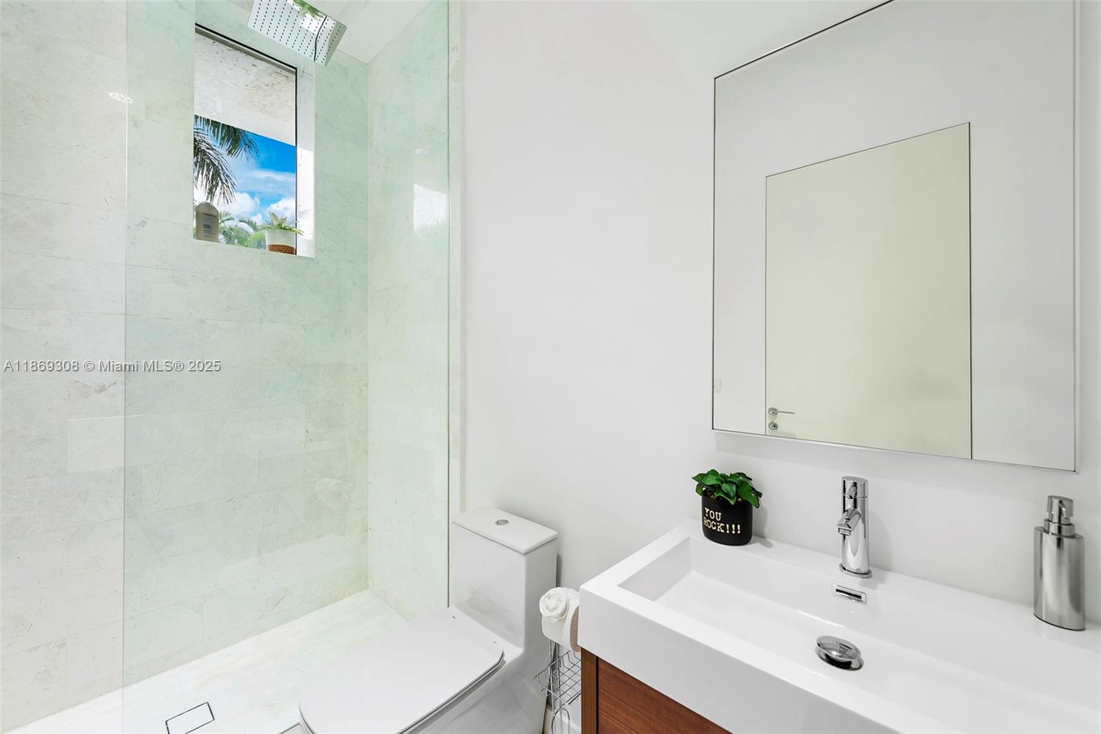 7450 Southwest 102nd Street Pinecrest, FL 33156 - Photo 37 of 51 a bathroom with a sink and a mirror