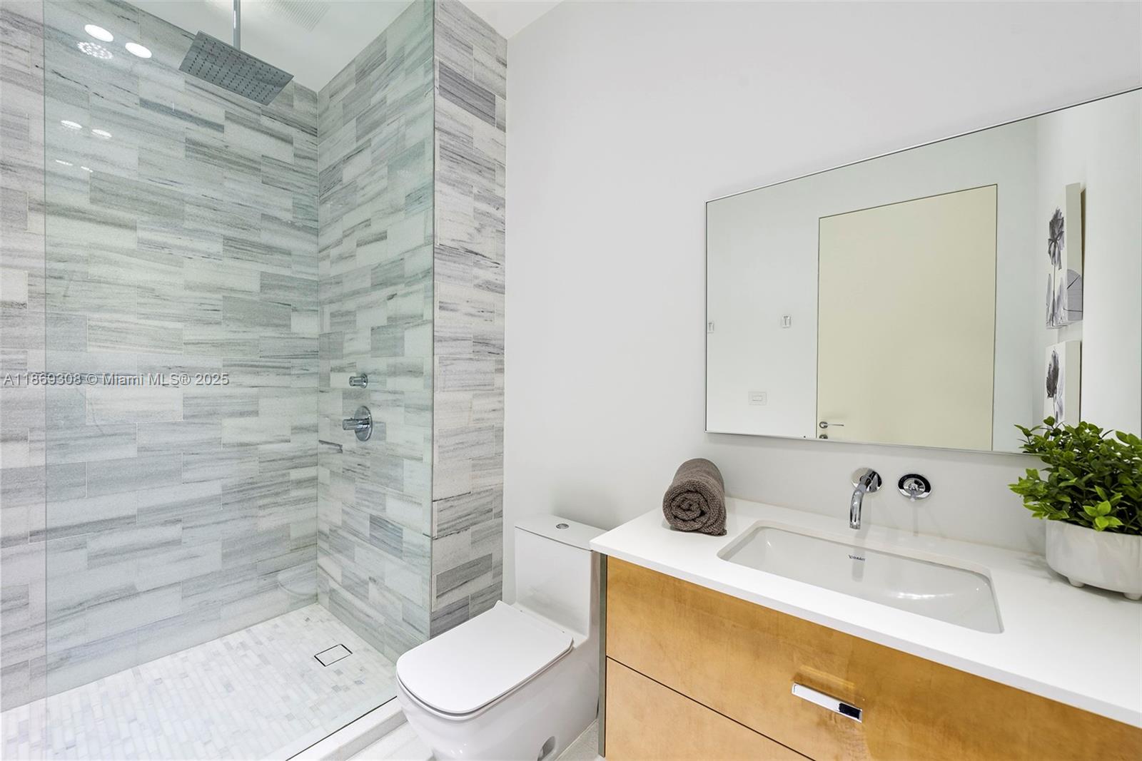 7450 Southwest 102nd Street Pinecrest, FL 33156 - Photo 42 of 51 a bathroom with a sink a toilet and shower