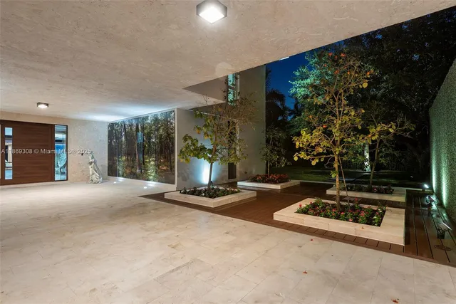 a view of a house with a yard and parking space