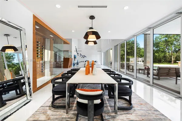 a view of a dining room with furniture wooden floor and chandelier