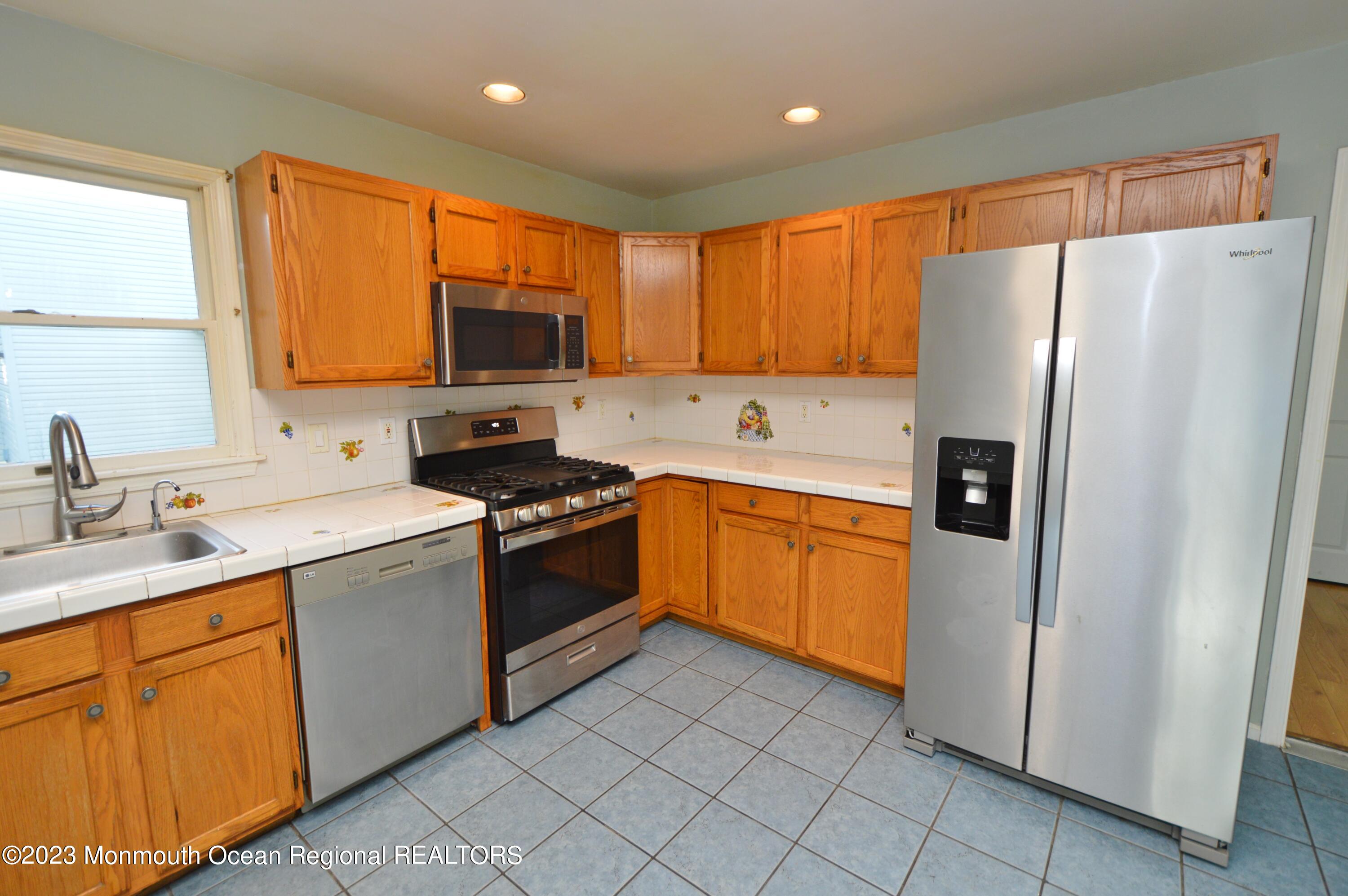 271 Sextant Road Manahawkin, NJ 08050 - Photo 16 of 48 a kitchen with a sink refrigerator and microwave
