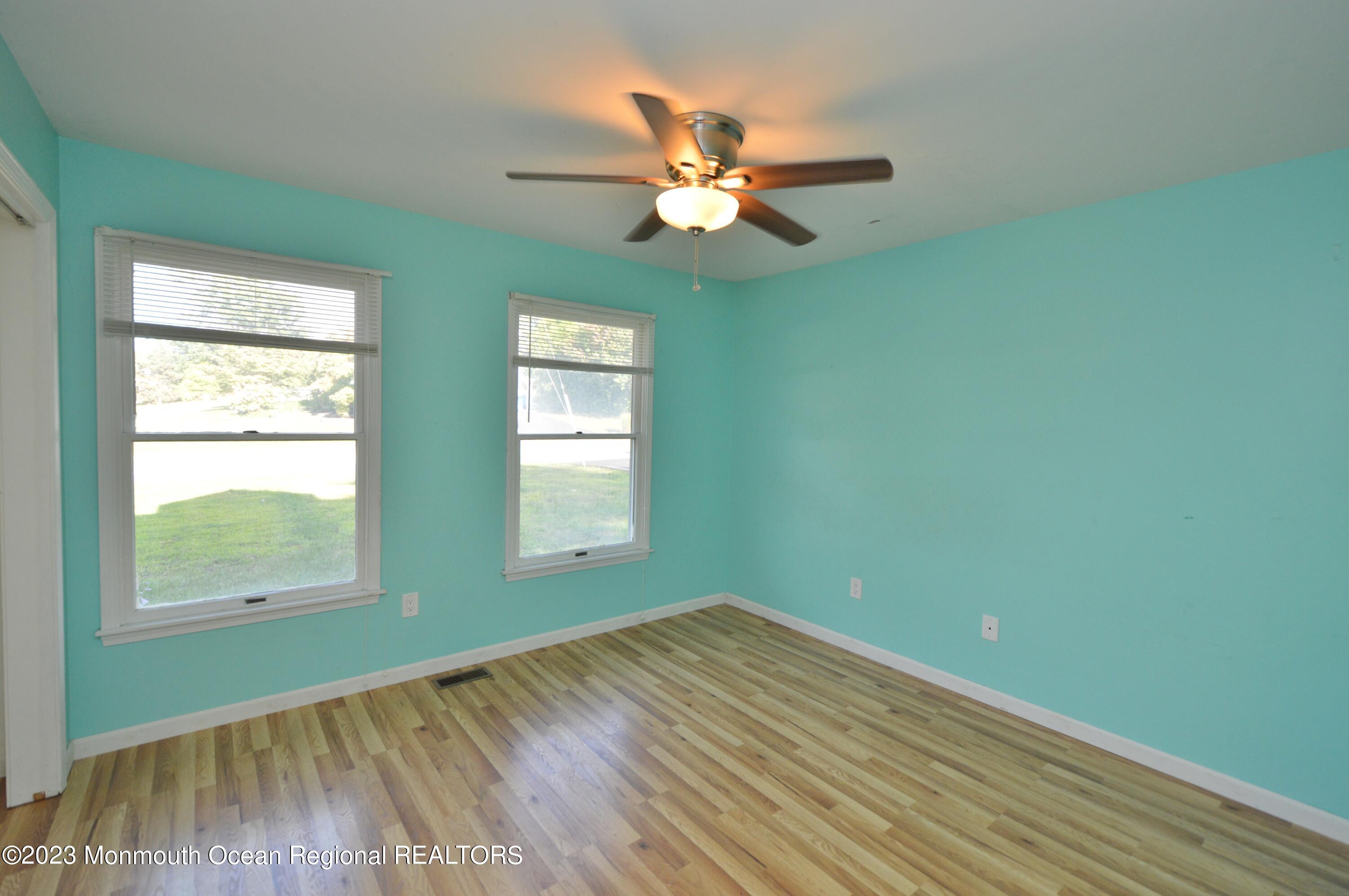 271 Sextant Road Manahawkin, NJ 08050 - Photo 23 of 48 a view of empty room with wooden floor and fan