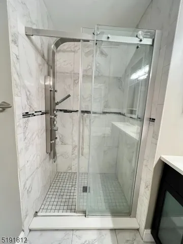 a bathroom with a glass shower door