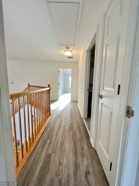 22 Constitution Way Bernards, NJ 07920 - Photo 15 of 19 a view of a hallway with wooden floor and staircase