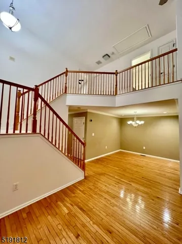 a view of staircase with white walls and wooden floor